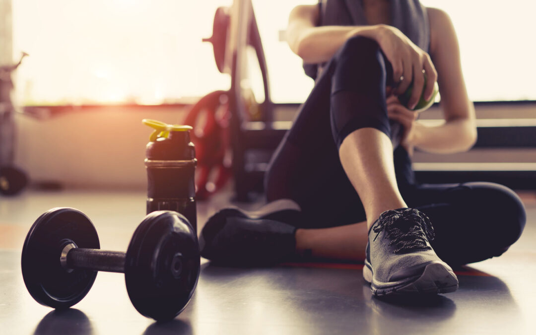 Woman Sitting Next To Weights