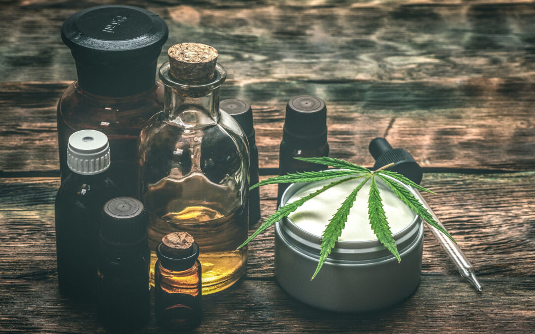 Cannabis face cream or moisturizer jar and cbd oil bottles concept